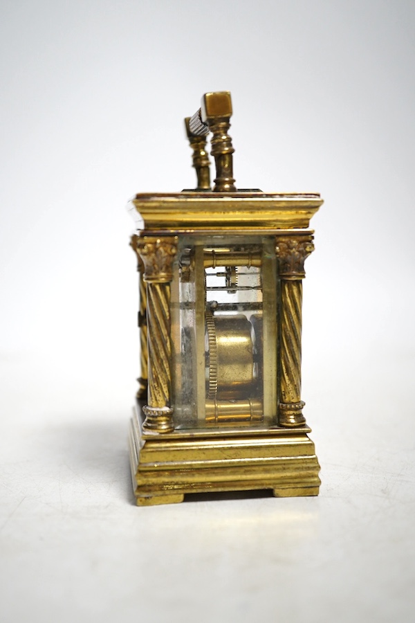 A miniature carriage timepiece, with four ornate corner columns, turquoise dial and gilt filigree mount, 8cm high. Condition - fair, not tested as working